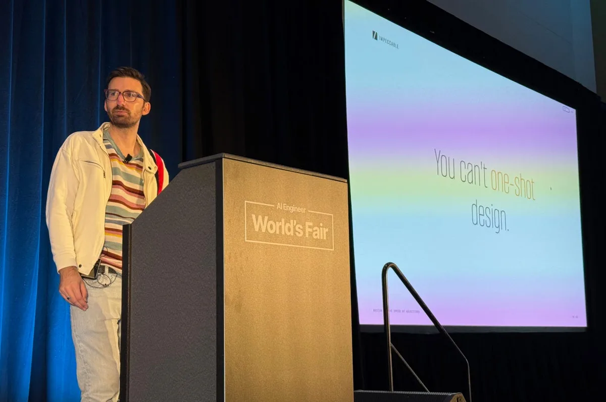 A speaker stands beside a World’s Fair lectern and a projected Impeccable slide reading “You can’t one-shot design.”